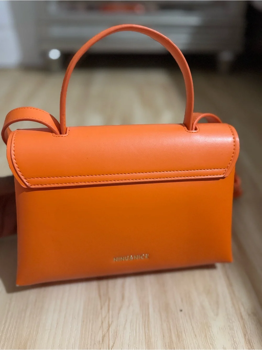 Structured Orange Leather Satchel with Gold Chain Accent